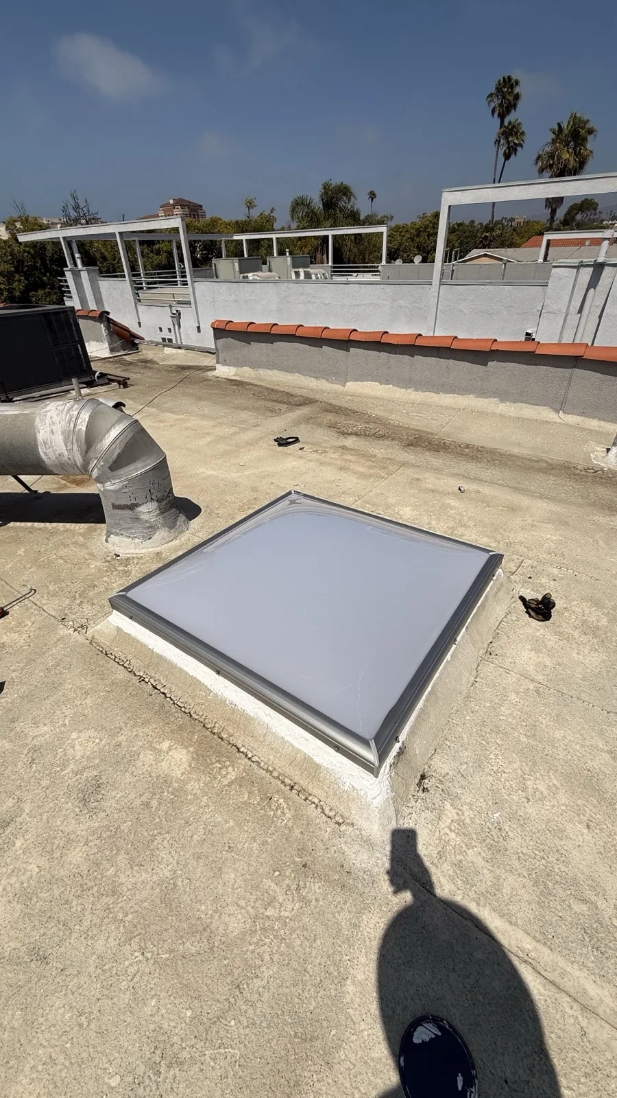 Polycarbonate dome skylight installed on an asphalt shingle roof in Los Angeles